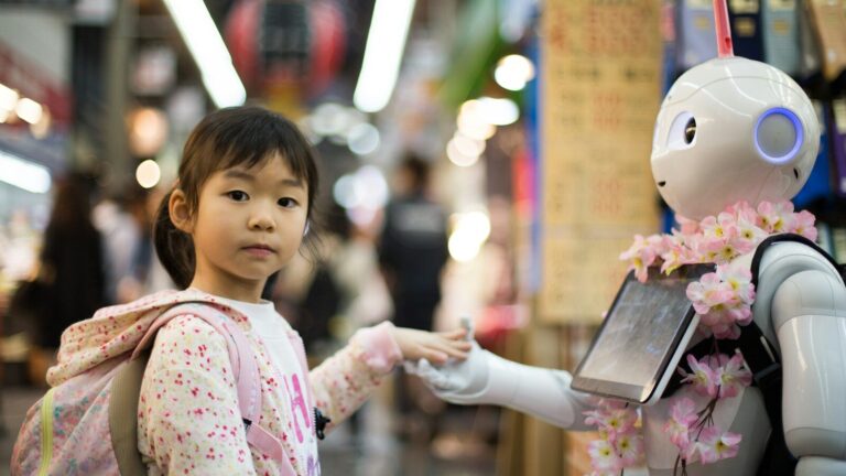 photo of girl laying left hand on white digital robot