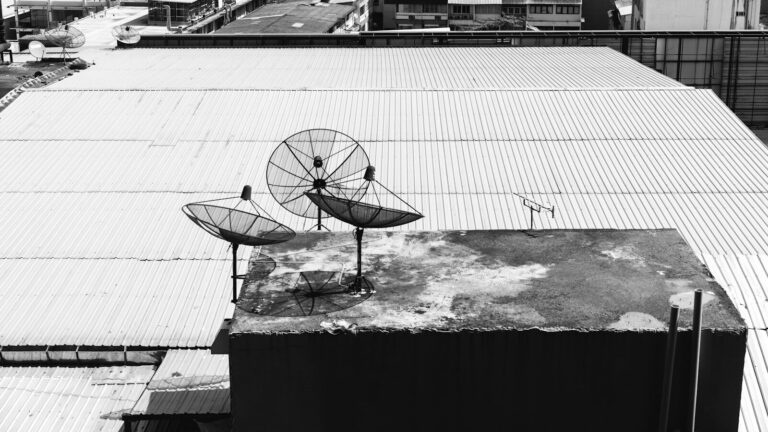 a black and white photo of a satellite dish on a roof