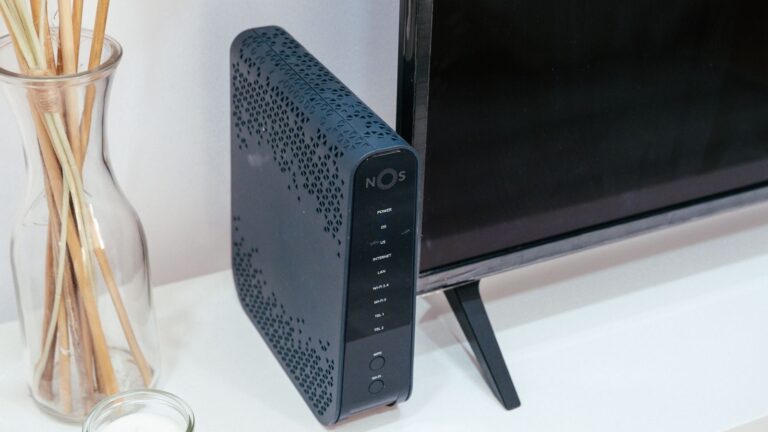 A sleek home technology setup featuring a router, glass decoration, and television.