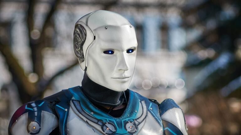 Close-up of a futuristic humanoid robot with metallic armor and blue LED eyes.