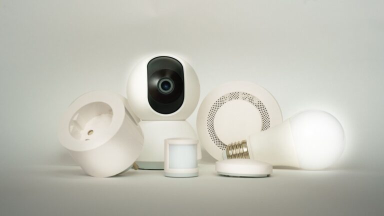 A collection of smart home devices, including a camera, light bulb, and sensors, on display.