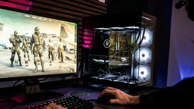 A man is playing a video game on his computer
