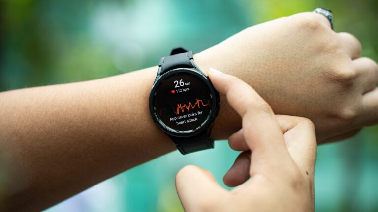 a close up of a person holding a smart watch