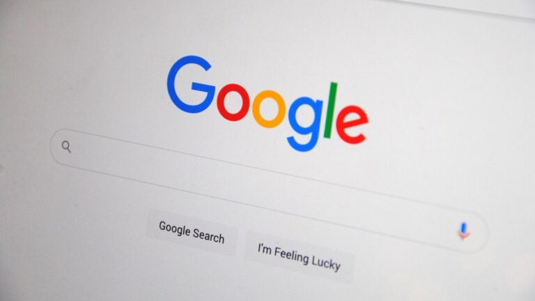 Close-up of the Google homepage on a screen showing search options.