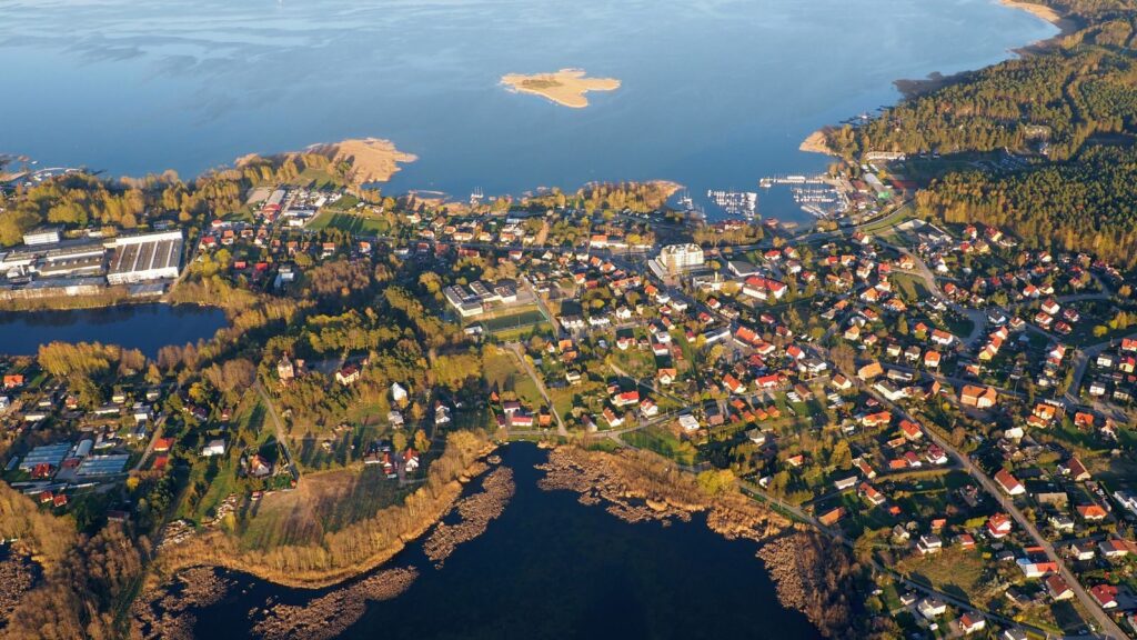 A stunning aerial view of a coastal town surrounded by water and lush greenery.