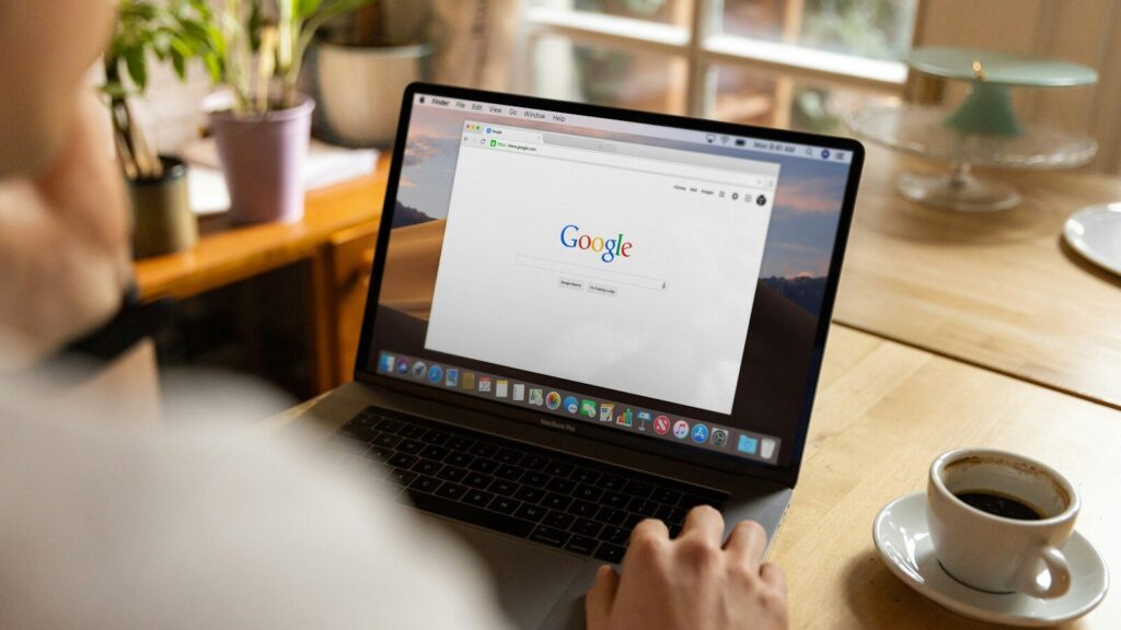 person using macbook pro on table