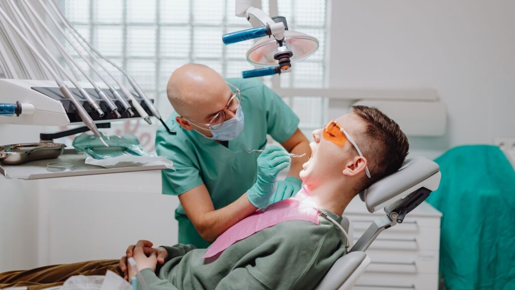 Patient receives dental check-up from experienced dentist in a modern clinic.