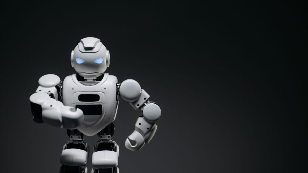 A sleek white robot showcasing modern robotics technology against a dark backdrop.