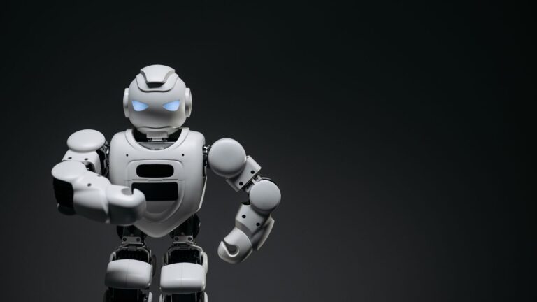 A sleek white robot showcasing modern robotics technology against a dark backdrop.