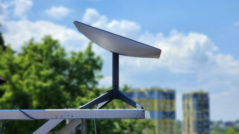 a white surfboard sitting on top of a metal pole