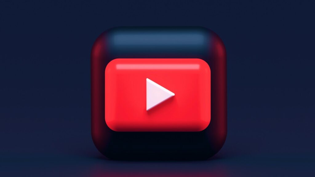A 3D red play button icon on a dark blue background