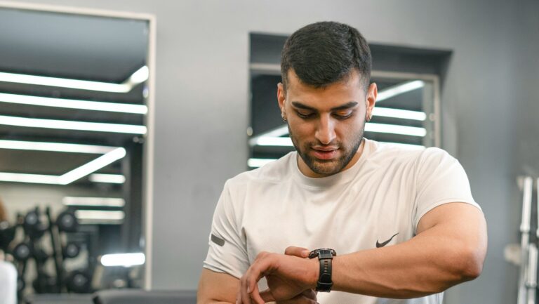 Man checking smartwatch in a gym