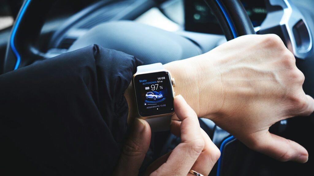 person holding gold aluminum Apple Watch
