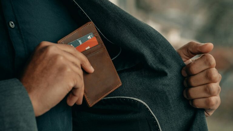 a man holding a wallet in his pocket