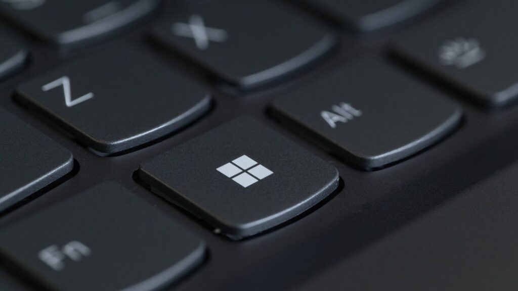 Detailed close-up of a computer keyboard featuring the Windows key in focus.