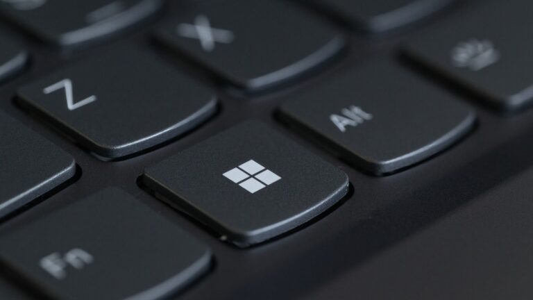 Detailed close-up of a computer keyboard featuring the Windows key in focus.