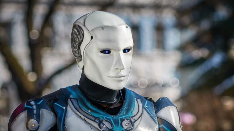 Close-up of a futuristic humanoid robot with metallic armor and blue LED eyes.