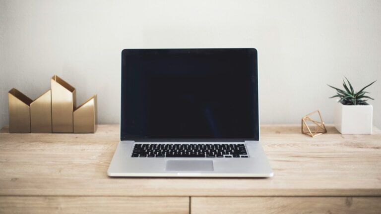 MacBook Pro on top of brown table