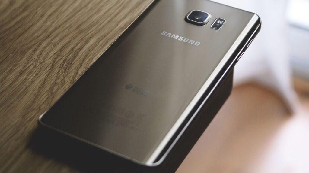A sleek Samsung smartphone placed on a wooden surface, capturing modern elegance.