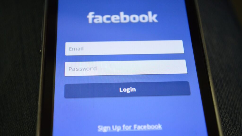 Close-up of a smartphone screen showing the Facebook login interface.