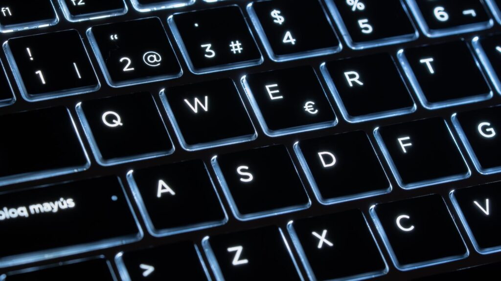 Illuminated mechanical keyboard keys in close-up, showcasing modern design and technology.