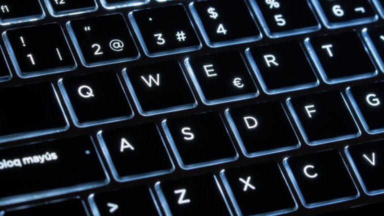 Illuminated mechanical keyboard keys in close-up, showcasing modern design and technology.