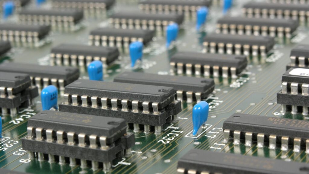 Detailed macro shot showcasing integrated circuits and components on electronic motherboard.