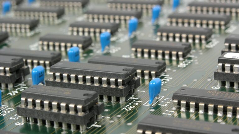 Detailed macro shot showcasing integrated circuits and components on electronic motherboard.
