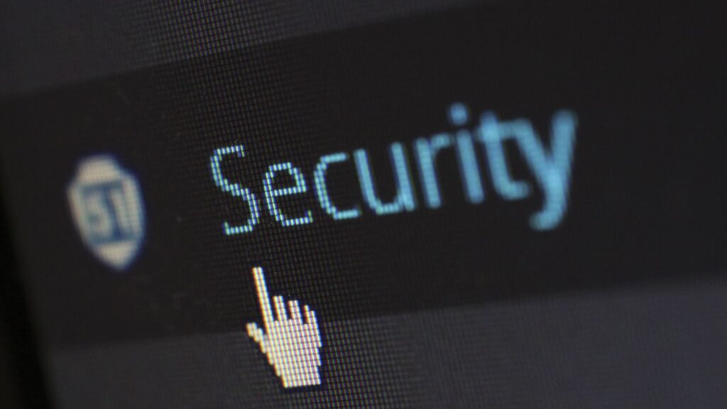 Close-up view of a mouse cursor over digital security text on display.