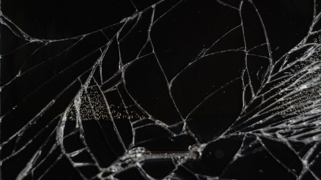 Close-up view of shattered glass showing delicate fragments and patterns.