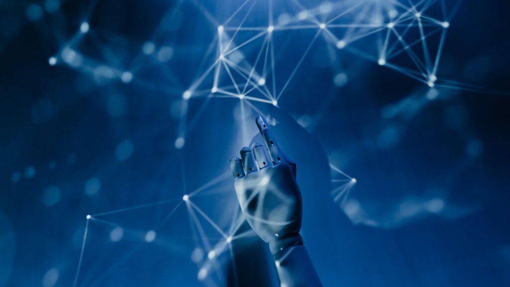 A robotic hand reaching into a digital network on a blue background, symbolizing AI technology.