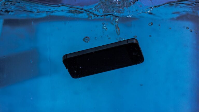 A smartphone captured underwater, illustrating themes of technology and water resistance.
