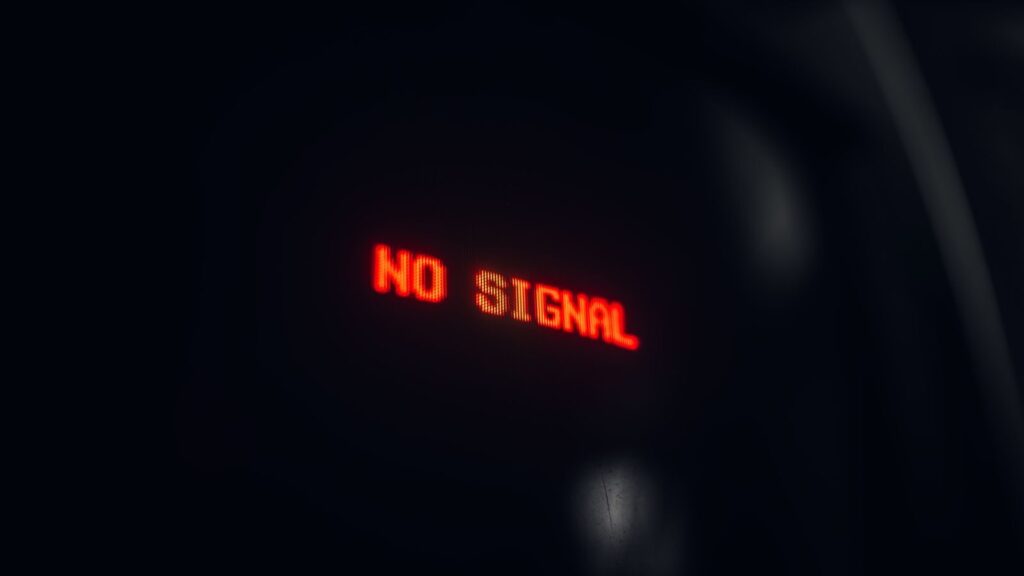 A red LED display indicating 'No Signal' in a dark setting, conveying a tech warning.