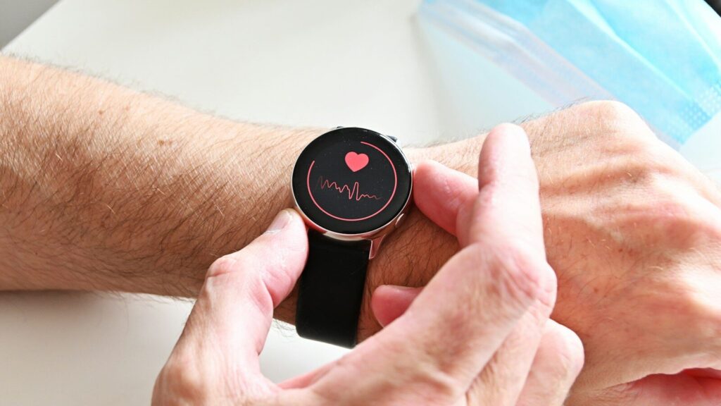 A person checking a heart rate monitor on a smartwatch on their wrist