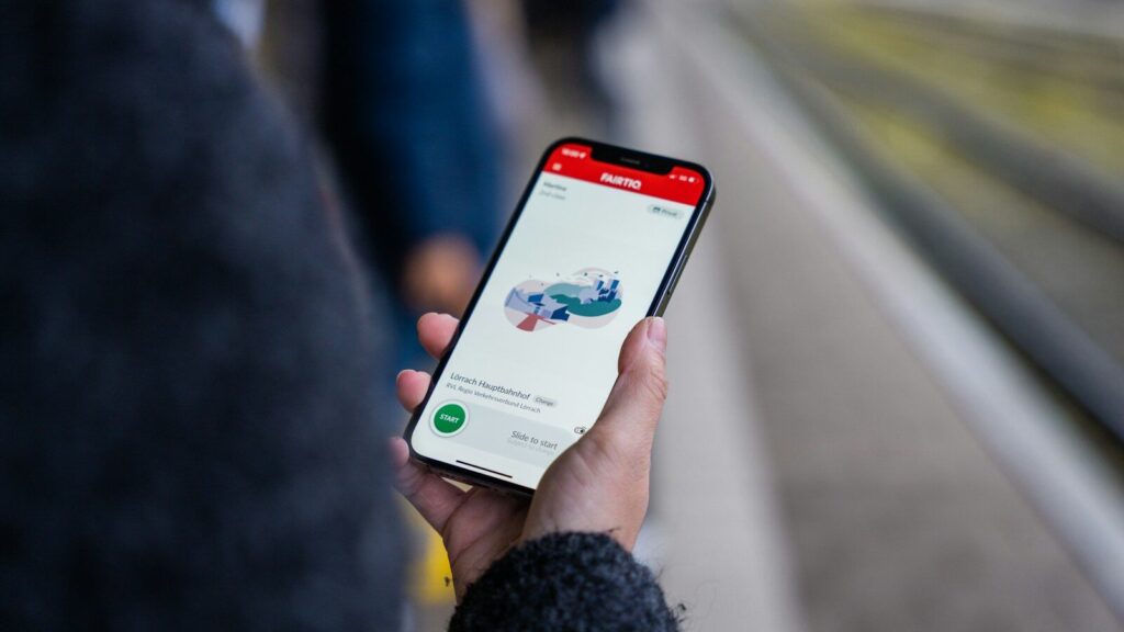 A person holding a cell phone in their hand
