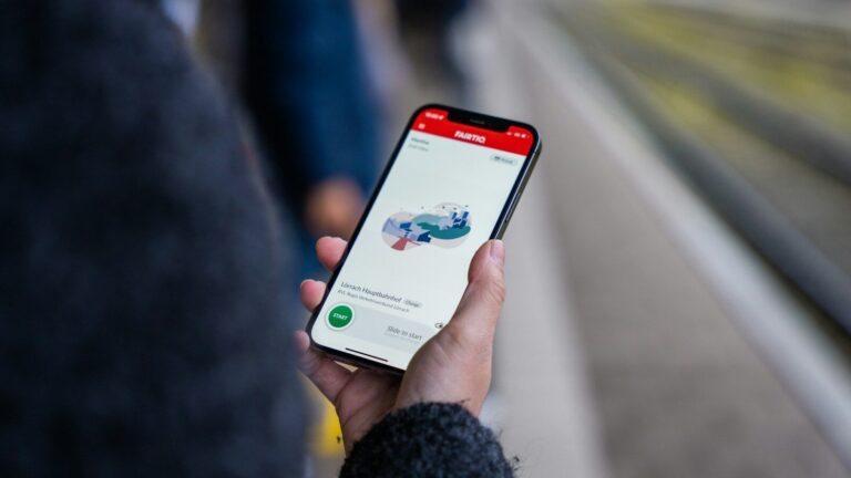 A person holding a cell phone in their hand