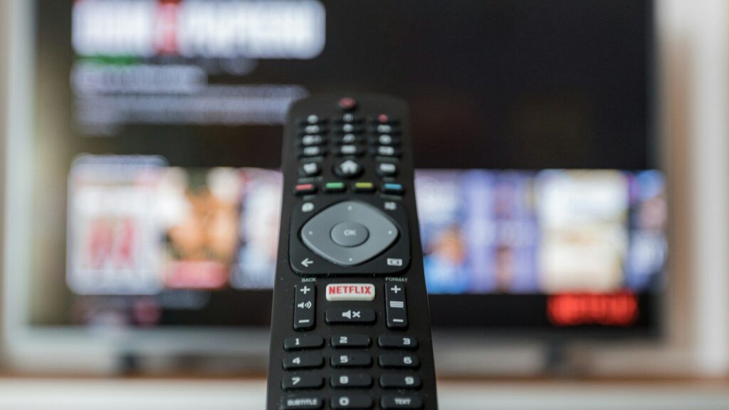 black remote control on brown wooden table