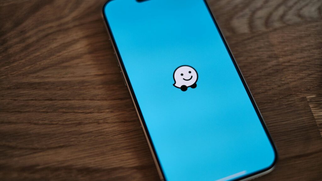 A phone with a sticker of a smiley face on it