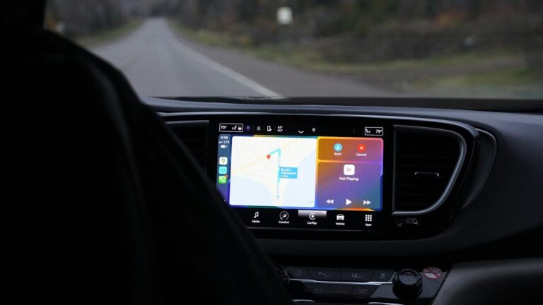 a man driving a car with a gps device in his hand