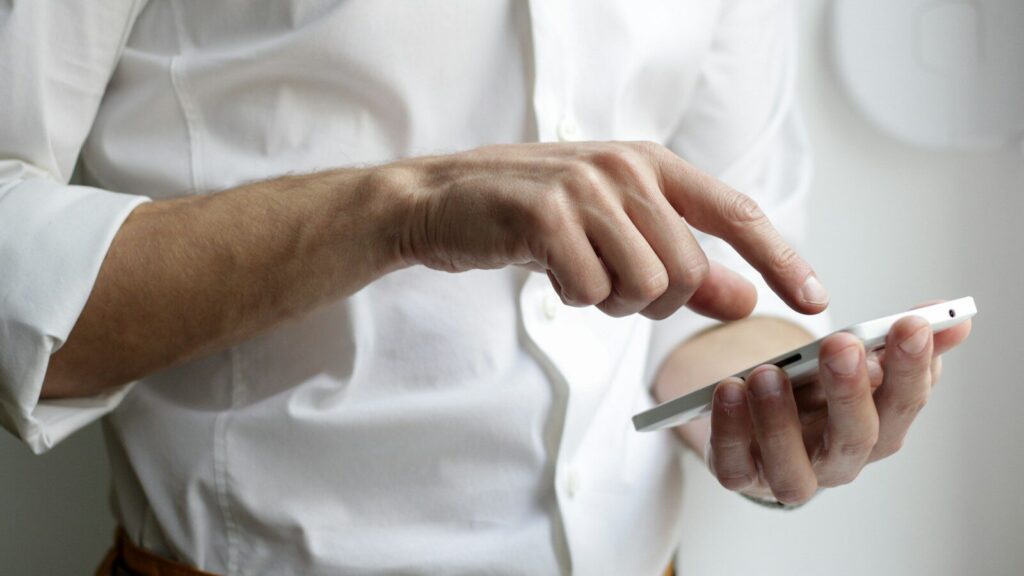 person holding white Android smartphone in white shirt