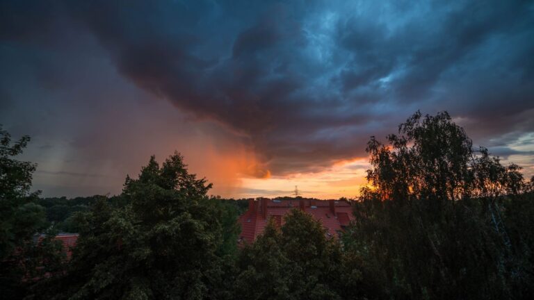 Dramatic clouds at sunset over Szczecin rooftops, capturing the evening ambiance and skyline.