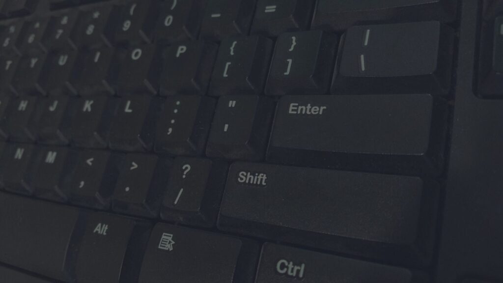 Detailed shot of black computer keyboard showcasing various keys for technology concepts.