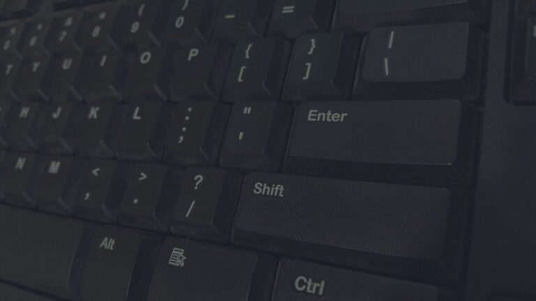 Detailed shot of black computer keyboard showcasing various keys for technology concepts.