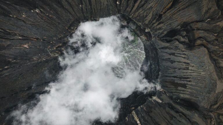 Aerial view of scenery with powerful rough soaring volcanic crater located in mountainous area