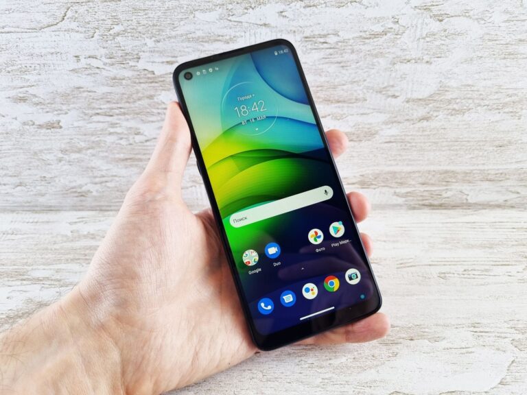 Close-up of a hand holding a smartphone with vibrant screen indoors, bright and clear display.