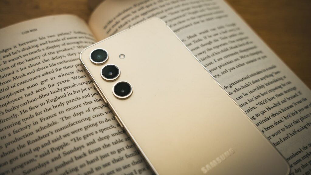 a close up of a cell phone on a book