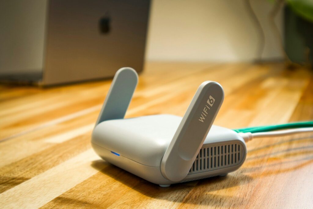A wireless router sits on a wooden table
