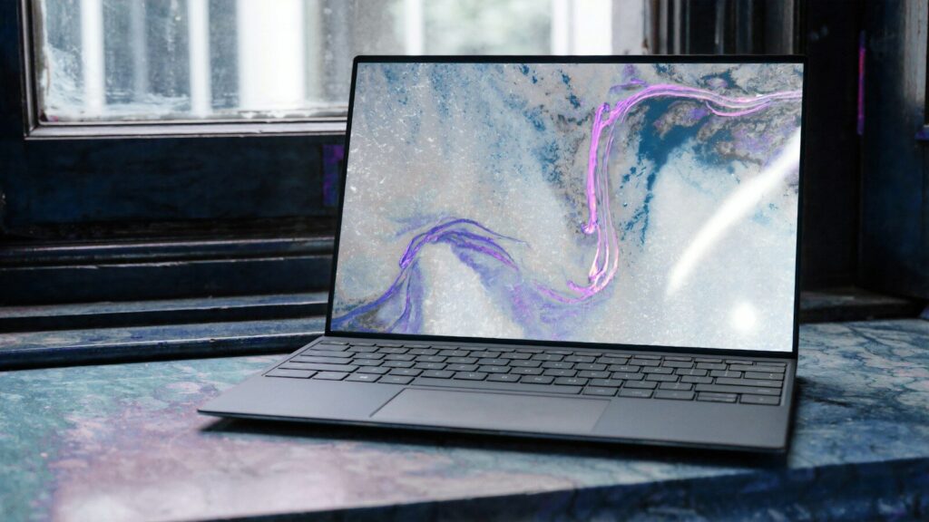A laptop displaying an abstract blue and purple pattern on a marble surface